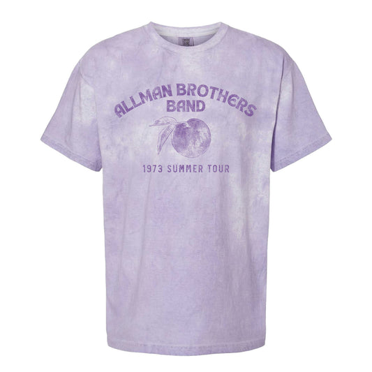 This image features the "Allman Brothers Band Colorblast 73 Summer Tee," a nostalgic and eye-catching t-shirt. The tee is rendered in a light purple color, with the band's name and the text "1973 Summer Tour" printed across the front in a matching shade of purple.